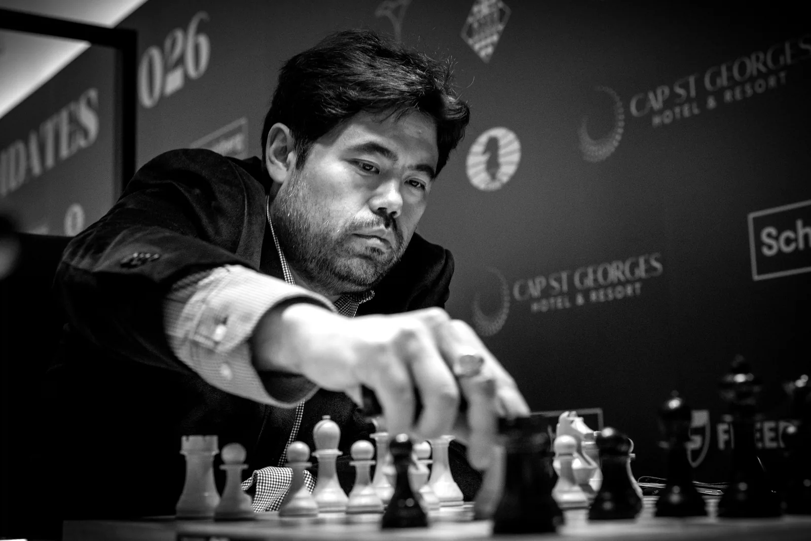 Hikaru Nakamura reaches across the board to make a move at the 2026 Candidates in Cyprus.